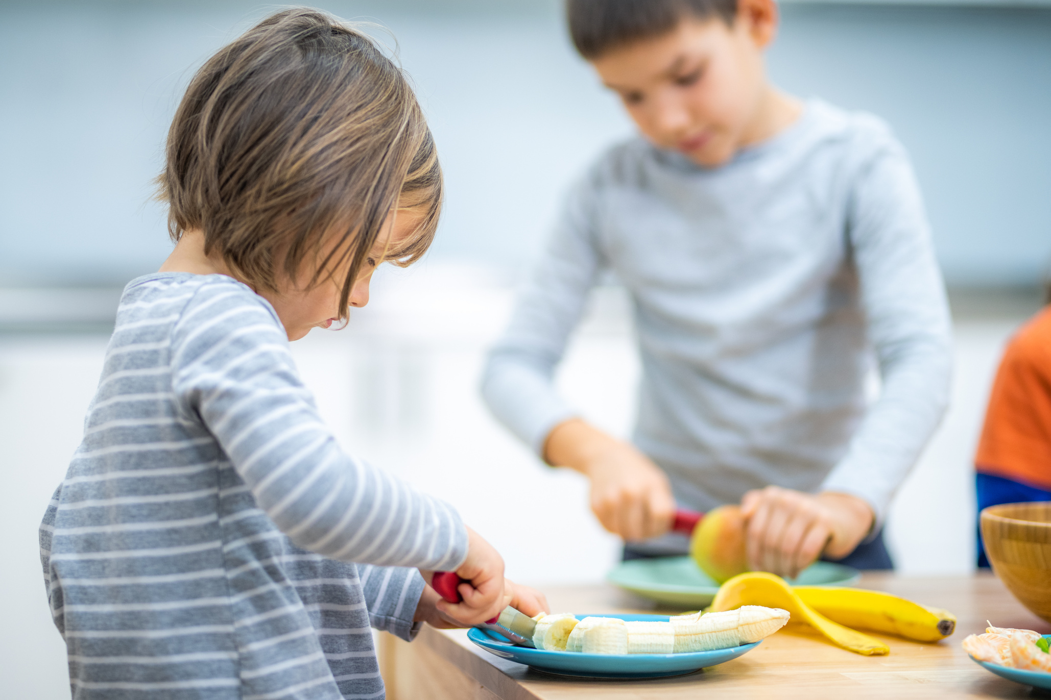 Children cutting fruits