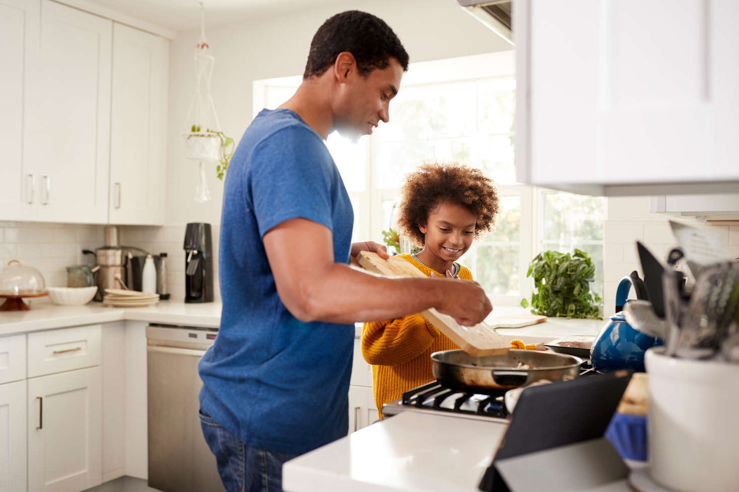 Father Teaching Daughter How to Cook